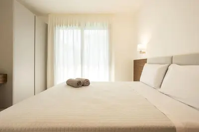 a white bed with a towel on top of it at Luxury Jacuzzi Villa Nettuno in Palermo