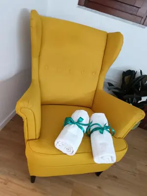 two towels sitting on a yellow chair at Kalos suite in Palermo