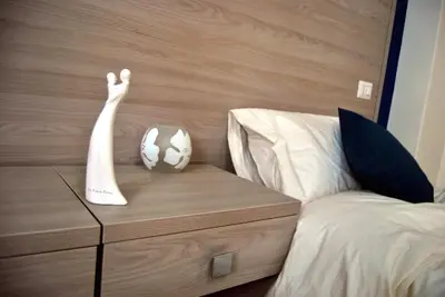 a bed with a dresser with a soccer ball on it at Il Quadrifoglio Room& Suite in Palermo
