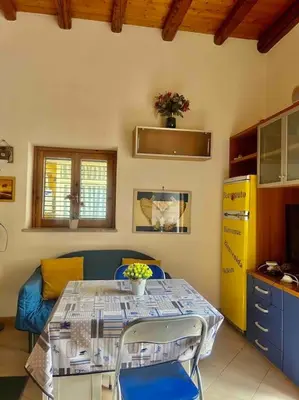 a kitchen with a table and chairs in a room at Fra centro & mare in Palermo