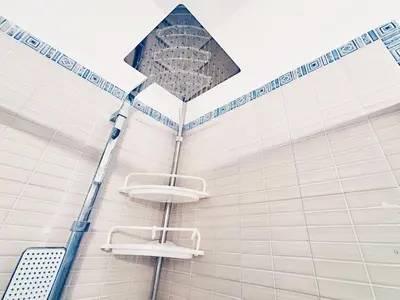 a shower with two sinks on a wall at Casa Cassarelli in Centro in Palermo