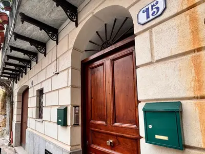 a wooden door on a building with a sign above it at Casa Cassarelli in Centro in Palermo