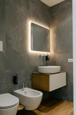 a bathroom with a sink and a toilet and a mirror at Spasimo Hôtellerie in Palermo