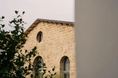 a brick building with a black roof at Spasimo Hôtellerie in Palermo