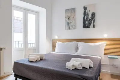 a bedroom with a large bed with towels on it at GuestHost - Mezzojuso Central Apartment near Via Roma in Palermo