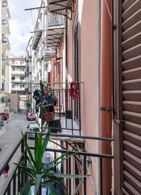 a balcony of a building with a plant at GuestHost - Mezzojuso Central Apartment near Via Roma in Palermo