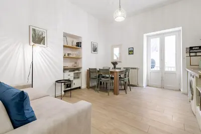 a living room with a couch and a table at GuestHost - Mezzojuso Central Apartment near Via Roma in Palermo