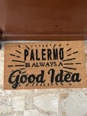 a door mat with a sign that says malaria is always a good idea at Vito's holiday house in Palermo