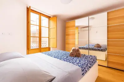 a bedroom with a bed with shoes on it at La Terrazza del Garraffello in Palermo