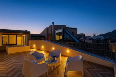 a patio with chairs and a table on a balcony at La Terrazza del Garraffello in Palermo