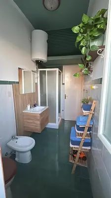 a bathroom with a toilet and a sink at CalaMia in Palermo