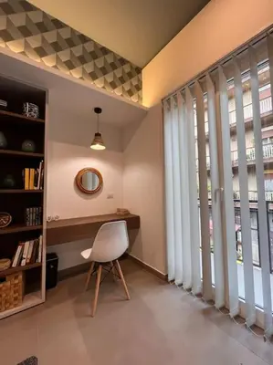 a room with a chair and a desk and windows at Cantù Home in Misilmeri
