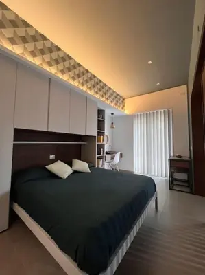 a bedroom with a large bed in a room at Cantù Home in Misilmeri