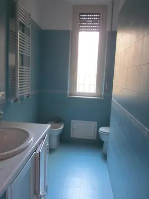 a blue bathroom with a sink and a toilet at Panormus Home&Apartaments in Palermo