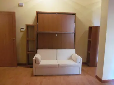 a living room with a white couch and a closet at Panormus Home&Apartaments in Palermo