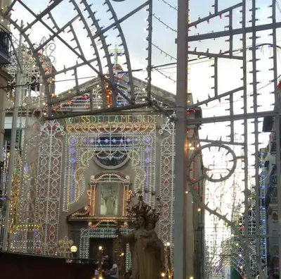a christmas market with a statue and christmas lights at Accasetta in Palermo