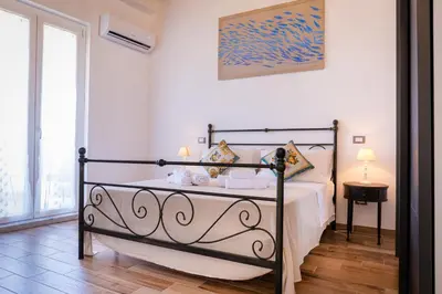 a bedroom with a bed with towels on it at Vanda's Terrace in Palermo