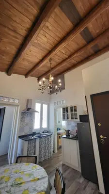 a kitchen and dining room with a table in a room at Vanda's Terrace in Palermo