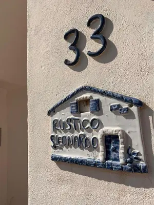a house sign on the side of a building at Rustico San Leonardo in Cinisi