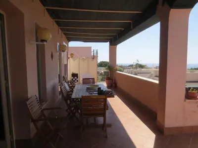 a patio with a table and chairs on a balcony at Casa Allegra Mondello in Palermo
