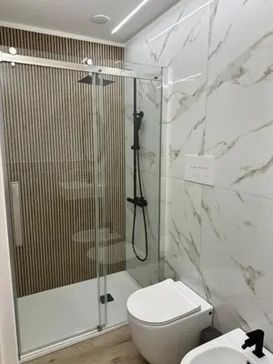 a bathroom with a shower and a white toilet at Palermo Mia in Palermo