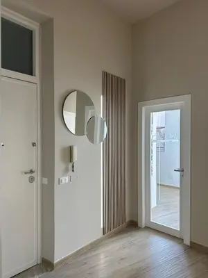 an empty room with a door and a mirror at Palermo Mia in Palermo