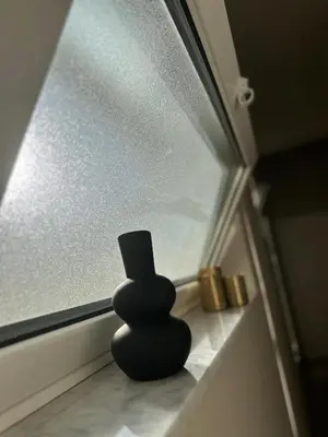 a black vase sitting on a window sill at Palermo Mia in Palermo