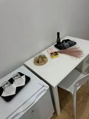a white table with a bottle of champagne on it at B&B Central Station in Palermo