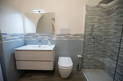 a bathroom with a toilet and a sink and a shower at Le 4 Stagioni-nelcuorediCorleone in Corleone