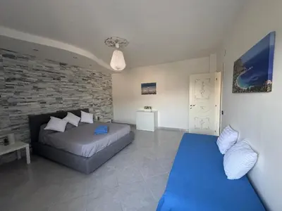 a bedroom with a bed and a brick wall at La Bella Vista in Palermo