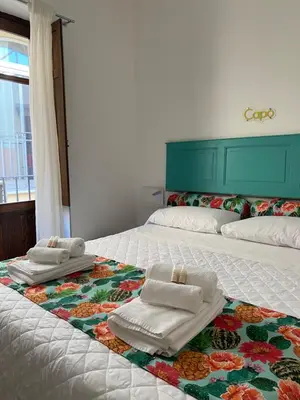 a bedroom with two beds with towels on them at 3Markets Rooms in Palermo