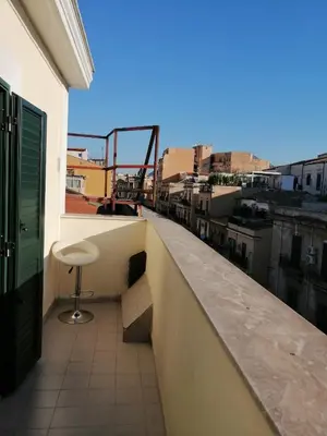 a view of a balcony with a stool on a building at Aurora house in Palermo