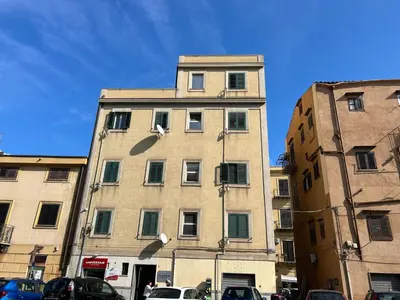 a tall building with cars parked in front of it at Aurora house in Palermo