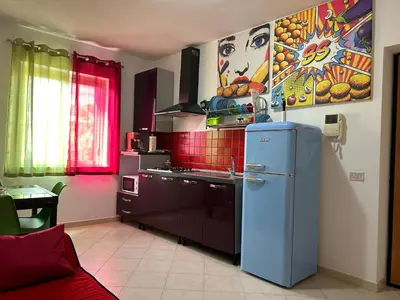 a kitchen with a blue refrigerator in a room at Aurora house in Palermo