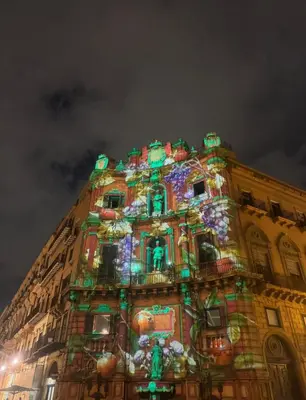 a building with christmas lights on it at night at Calderai Suite centro storico Palermo in Palermo