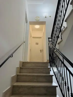 a hallway with stairs leading to a white door at Casa Katarina in Calatafimi