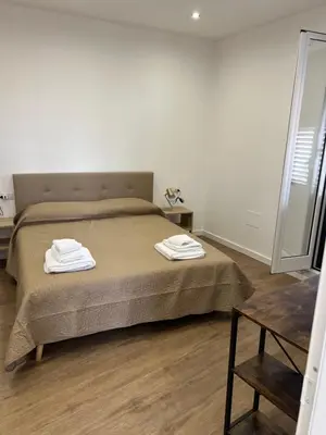 a bedroom with a bed with two towels on it at Scilia casa vacanza in Palermo