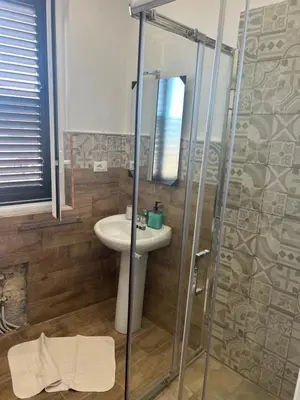 a bathroom with a sink and a shower at Scilia casa vacanza in Palermo