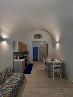 a kitchen and dining room with a table and chairs at La Maiolica 59 in Terrasini