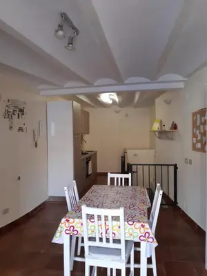 a dining room with a table and chairs at La casa del cocchiere in Palermo