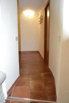 a hallway with a tiled floor in a house at La casa del cocchiere in Palermo