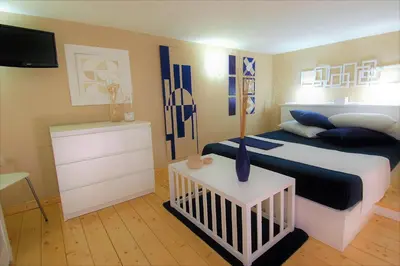 a bedroom with a bed and a crib in it at Virna House a Castellammare del Golfo in Castellammare del Golfo