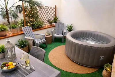 a bedroom with a bed with towels on it at Casa Meravigghia terrazzo ,giardino e Jacuzzi in Palermo