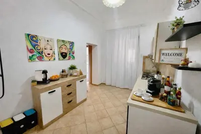 a kitchen with wooden cabinets and a counter top at Casa Meravigghia terrazzo ,giardino e Jacuzzi in Palermo