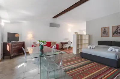 a living room with a bed and a glass table at Palazzo Mazzarino in Palermo