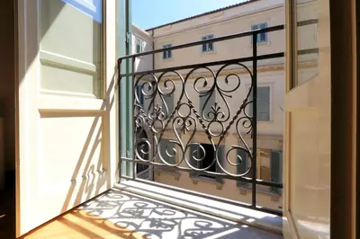 an open balcony with a view of a building at Palazzo Mazzarino in Palermo