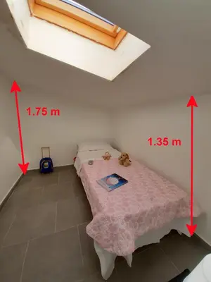 a bedroom with a bed and a skylight at Campofelice Holidays West Villa in Campofelice di Roccella