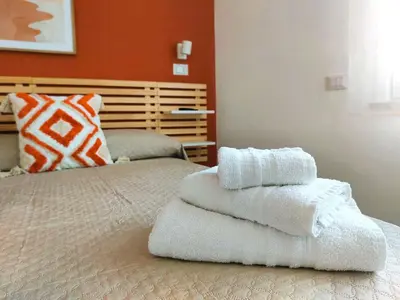 two beds with towels stacked on top of each other at Stefy's Home #Cattedrale in Palermo