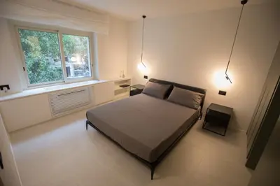 a bedroom with a bed and a window and lights at G&M Place in Palermo