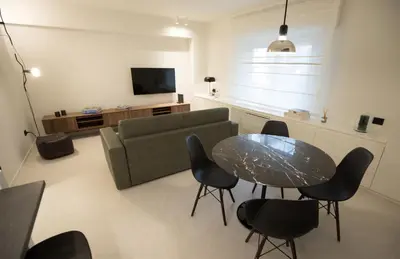 a living room with a couch and a table and chairs at G&M Place in Palermo